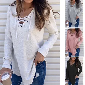 Detail of women's long sleeve V-neck lace-up loose fit casual top in multiple colors