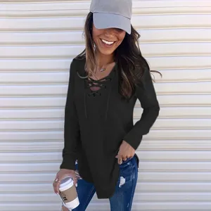 Women's casual black V-neck lace-up long sleeve top styled with jeans and a cap