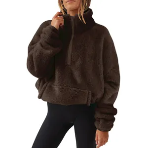 Detailed view of women's brown fuzzy half-zip fleece sweatshirt with stand collar
