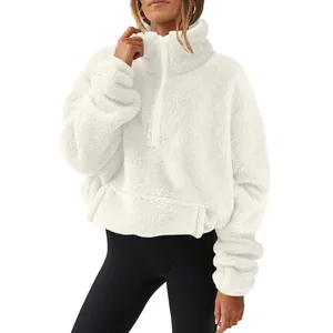 Close-up of white Sherpa fleece texture on a women's half-zip high-neck sweatshirt.
