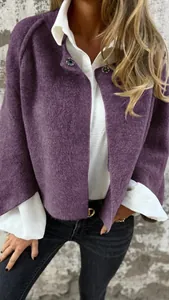 Detailed view of a soft purple cashmere jacket with a cropped fit and decorative buttons.