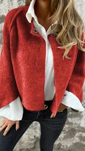 Detail shot of a vibrant red textured cashmere short jacket with white shirt