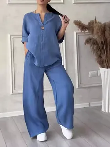 Casual blue two-piece linen set featuring a loose V-neck top and comfortable wide-leg pants