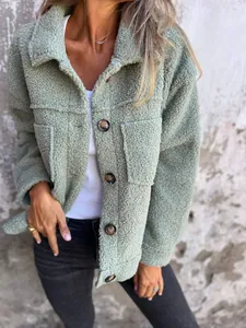 Close-up detail of sage green lamb wool jacket with tortoiseshell buttons and lapel collar