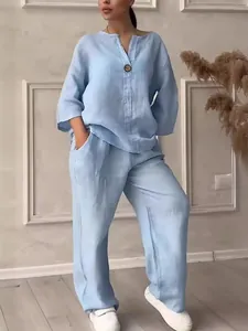 Loose light blue linen two-piece set for women with wide-leg trousers in indoor setting