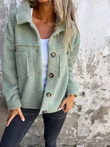 Close-up of sage green sherpa fleece jacket with button details and lapel collar