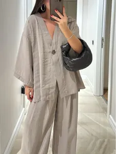 Detailed view of women's loose V-neck linen-style top and wide-leg pants set