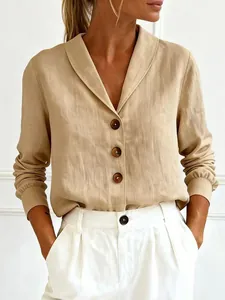 Detail shot of casual linen button-up blouse with shawl collar and decorative buttons.