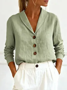 Close-up detail of a green linen long sleeve shirt with wooden buttons and a doll collar