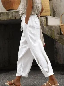 Detail shot of white linen wide-leg pants with elastic drawstring waist and side pockets