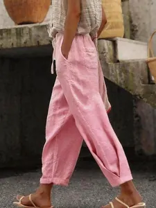 Side detail of pink cotton linen casual pants featuring a drawstring waist and side pockets.