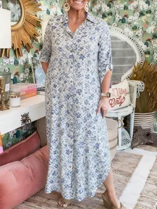 Elegant blue floral print button-down maxi shirt dress shown in a lifestyle setting