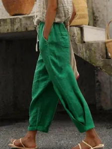 Side view of green cotton linen casual pants with elastic drawstring waist and pockets