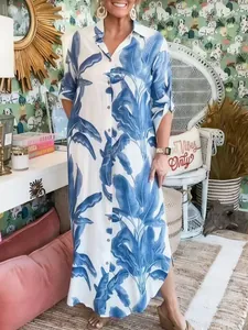 Women's blue tropical leaf print maxi shirt dress styled in a vibrant casual setting
