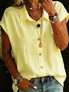 Close-up of a women's casual loose pale yellow short-sleeved lapel shirt with buttons