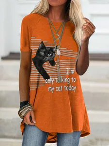 Detail view of orange t-shirt featuring black cat print and funny English slogan