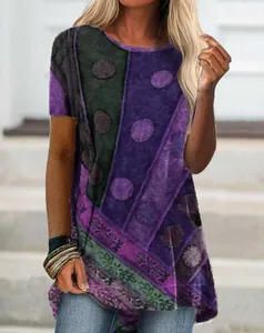 Detail of women's short sleeve tunic with purple digital polka dot and floral print.