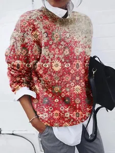 Détail d'un sweat-shirt à manches longues pour femme avec imprimé géométrique rouge et beige