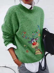 Close-up detail of a vibrant green knit sweater featuring a whimsical cartoon reindeer print