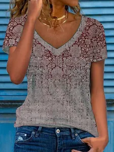 Close-up detail of women's loose V-neck top featuring a vintage floral print pattern.