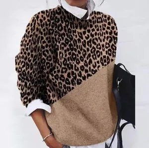 Detailed view of women's long sleeve casual top featuring diagonal leopard print panels