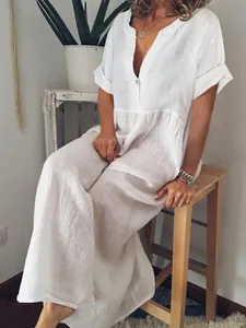 Full shot of white loose-fitting V-neck linen maxi dress with short sleeves and ruffles