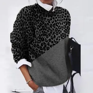 Close-up of the vintage leopard print and solid grey color-block fabric on long sleeve top