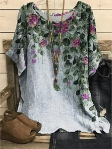 Boho style loose round neck top featuring vibrant leaf and floral print on linen texture
