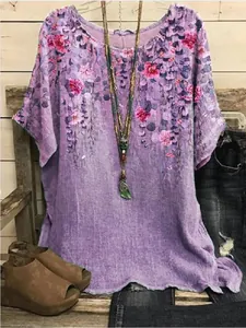 Casual purple short sleeve top with pink floral print on rustic wooden background