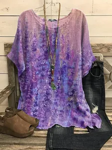Macro detail of bohemian purple floral print loose short sleeve top in rustic setting