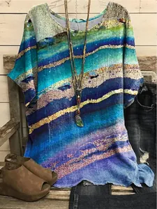 Close-up showing the vibrant blue and green marbled print on casual round neck top