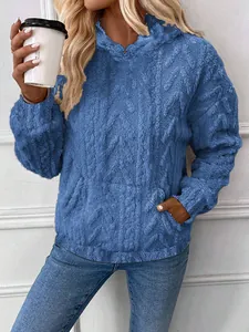Close-up of the blue textured fleece hoodie featuring jacquard patterns and front pocket