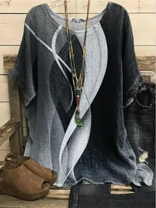 Detailed view of women's casual round neck top with abstract blue and grey prints.