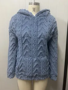 Macro view of blue jacquard plush hooded sweatshirt for women featuring textured fabric