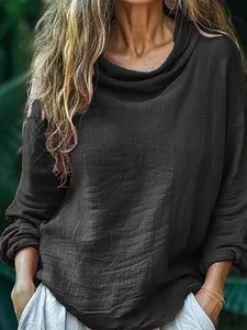 Detailed macro view of black textured pleated cowl neck long-sleeved casual women's top