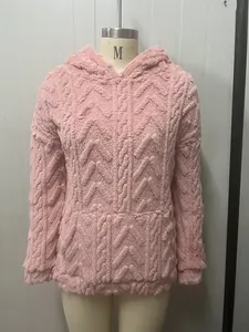 Detail view of pink fuzzy hoodie with thick cable-knit texture and kangaroo pocket