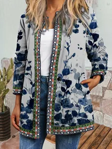 Close-up of vintage ethnic print cardigan with blue floral patterns and geometric borders.