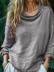 Close-up of grey long sleeve top featuring textured fabric and a draped cowl neckline