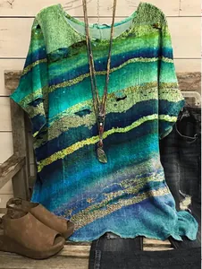 Casual loose short-sleeved top with vibrant abstract blue and green mineral print design.
