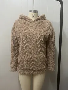 Macro detail of a women's brown fuzzy hooded sweatshirt with textured chevron patterns
