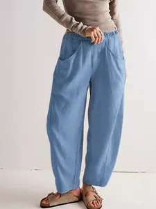 Side pocket detail on casual blue cotton linen loose-fit carrot trousers for women