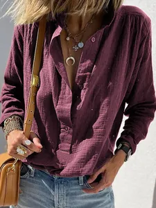 Detail of burgundy cotton-linen loose shirt with crinkle texture and retro buttons