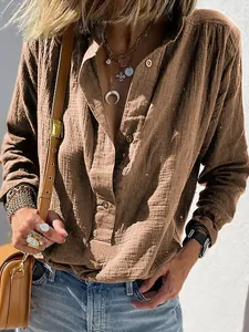 Close-up showing the textured cotton linen fabric of this loose retro button shirt