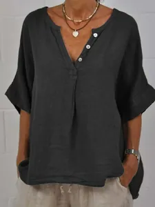 Close-up of casual loose cotton linen shirt with V-neck and button details