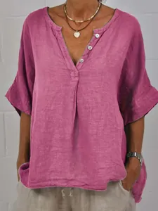Detailed close-up of a pink casual loose linen shirt featuring V-neck and button closure