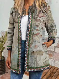 Close-up detail of vintage ethnic print cardigan featuring floral motifs and script patterns