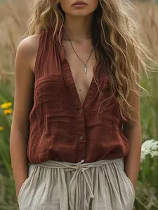 Close-up of a sleeveless rust-colored cotton linen V-neck vest shirt with pockets