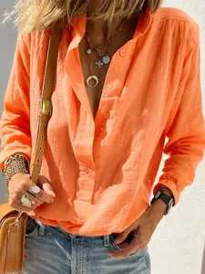 Casual orange long-sleeved cotton linen shirt for women showing fabric texture.