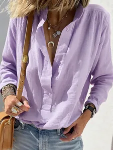 Close-up of a lavender loose-fitting long-sleeve linen shirt with elegant vintage buttons