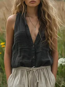 Detail view of casual sleeveless cotton linen V-neck shirt with pockets in charcoal.